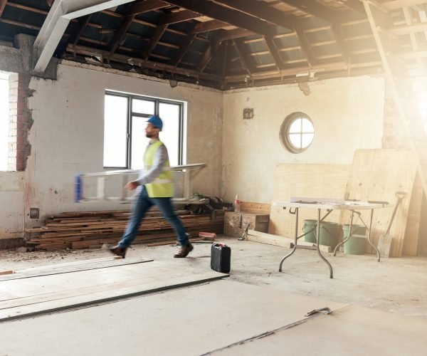 Construction, house and contractor walking in a building with maintenance, renovation and work with