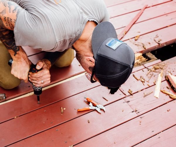 Man repairing wooden decking Man repairing wooden decking